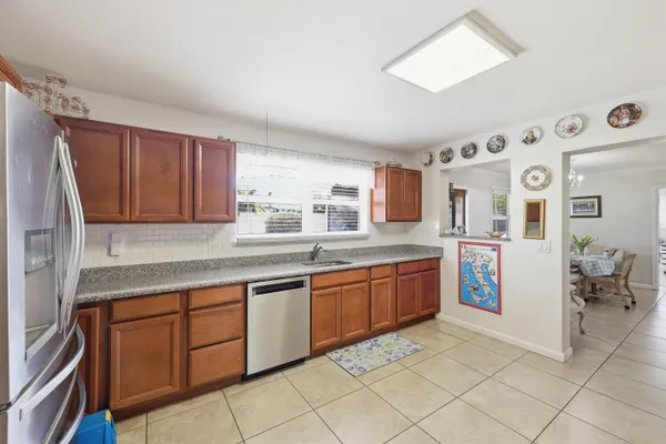 a large kitchen with stainless steel appliances granite countertop a sink and cabinets