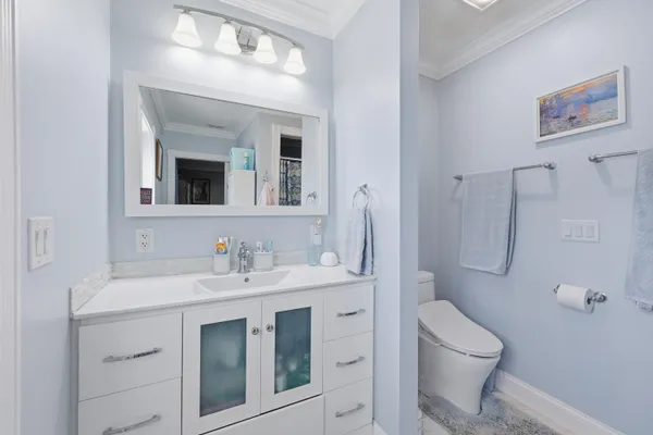 a bathroom with a toilet sink and mirror