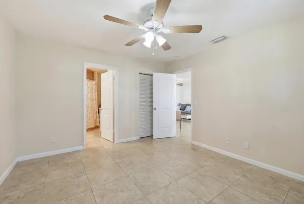 an empty room with fan and entryway