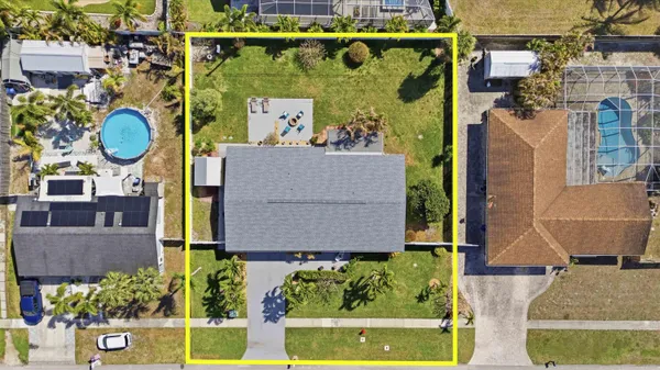 an aerial view of a house with yard swimming pool and outdoor seating
