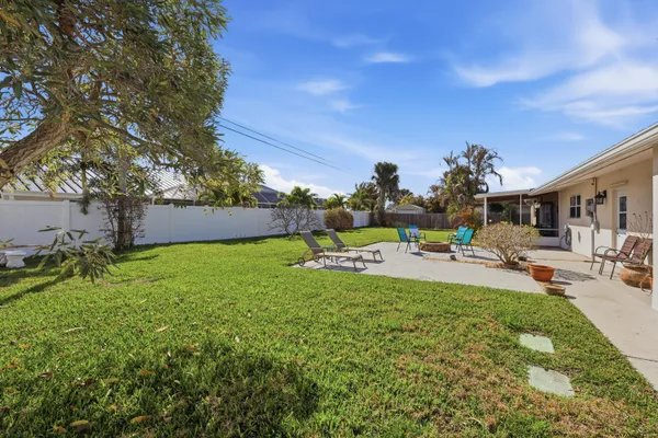 a view of a backyard with sitting area