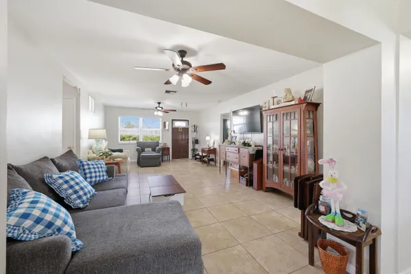 a living room with furniture and wooden floors