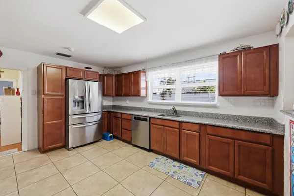 a kitchen with stainless steel appliances granite countertop a refrigerator sink and cabinets
