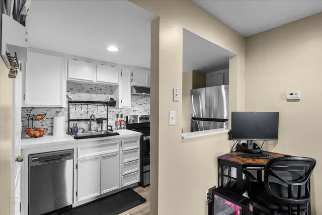 a kitchen with a stove and cabinets