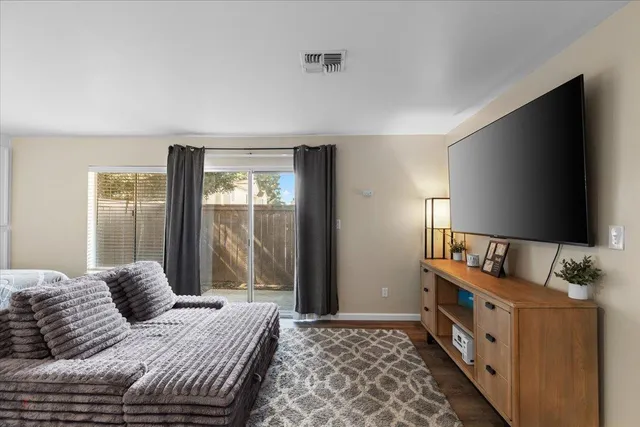 a room with wooden floor and a flat screen tv