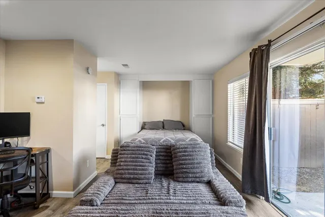 a bedroom with a bed and a window