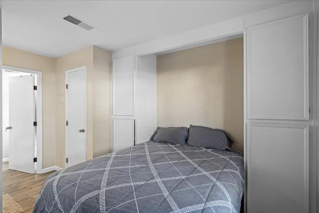 a bedroom with a bed and a large window