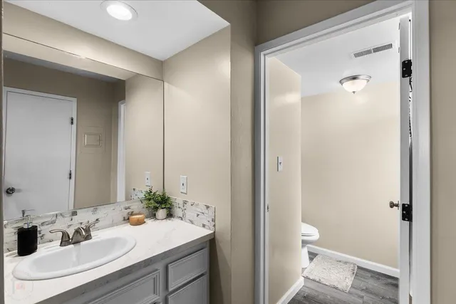 a kitchen with granite countertop a sink a stove and cabinets
