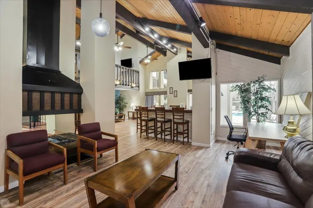 a living room with furniture a window and wooden floor