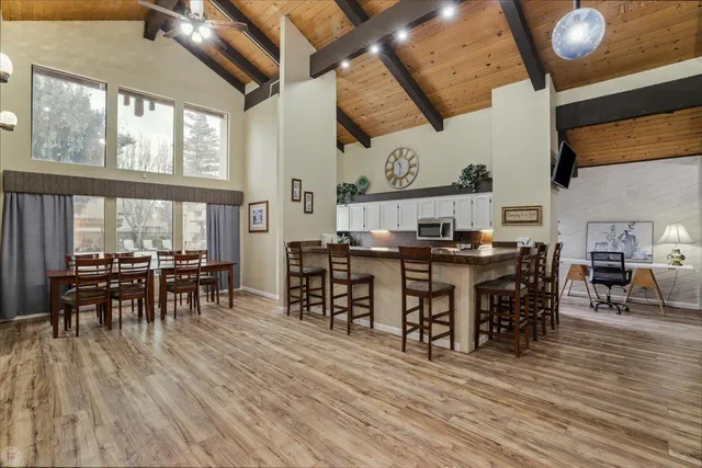 a open kitchen with stainless steel appliances kitchen island granite countertop a stove and cabinets with wooden floor