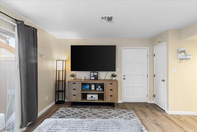 a bedroom with a bed and a view of kitchen