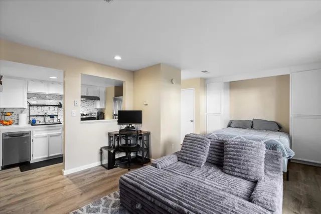 a kitchen with stainless steel appliances a refrigerator sink and white cabinets