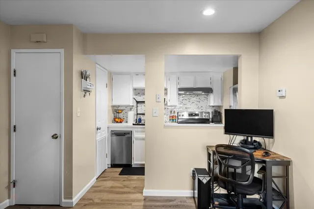 a bedroom with a sink and a mirror