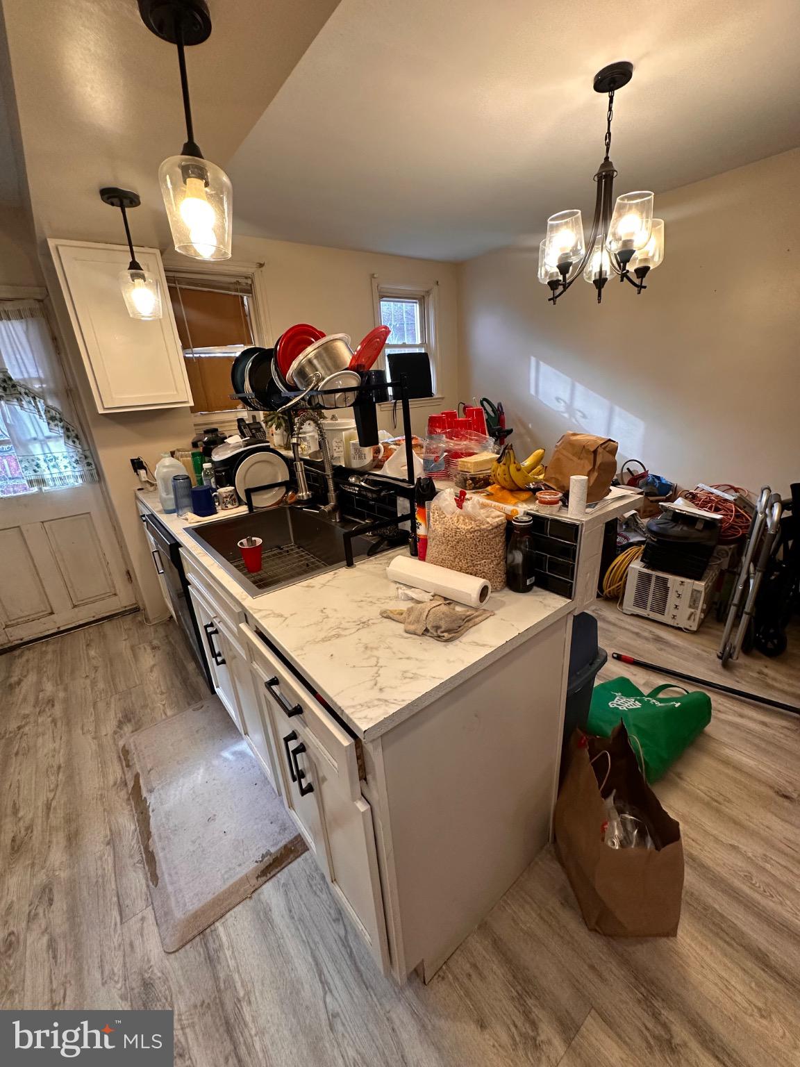 918 Cooks Lane Baltimore, MD 21229 - Photo 6 of 18 a kitchen with a stove and a wooden floor