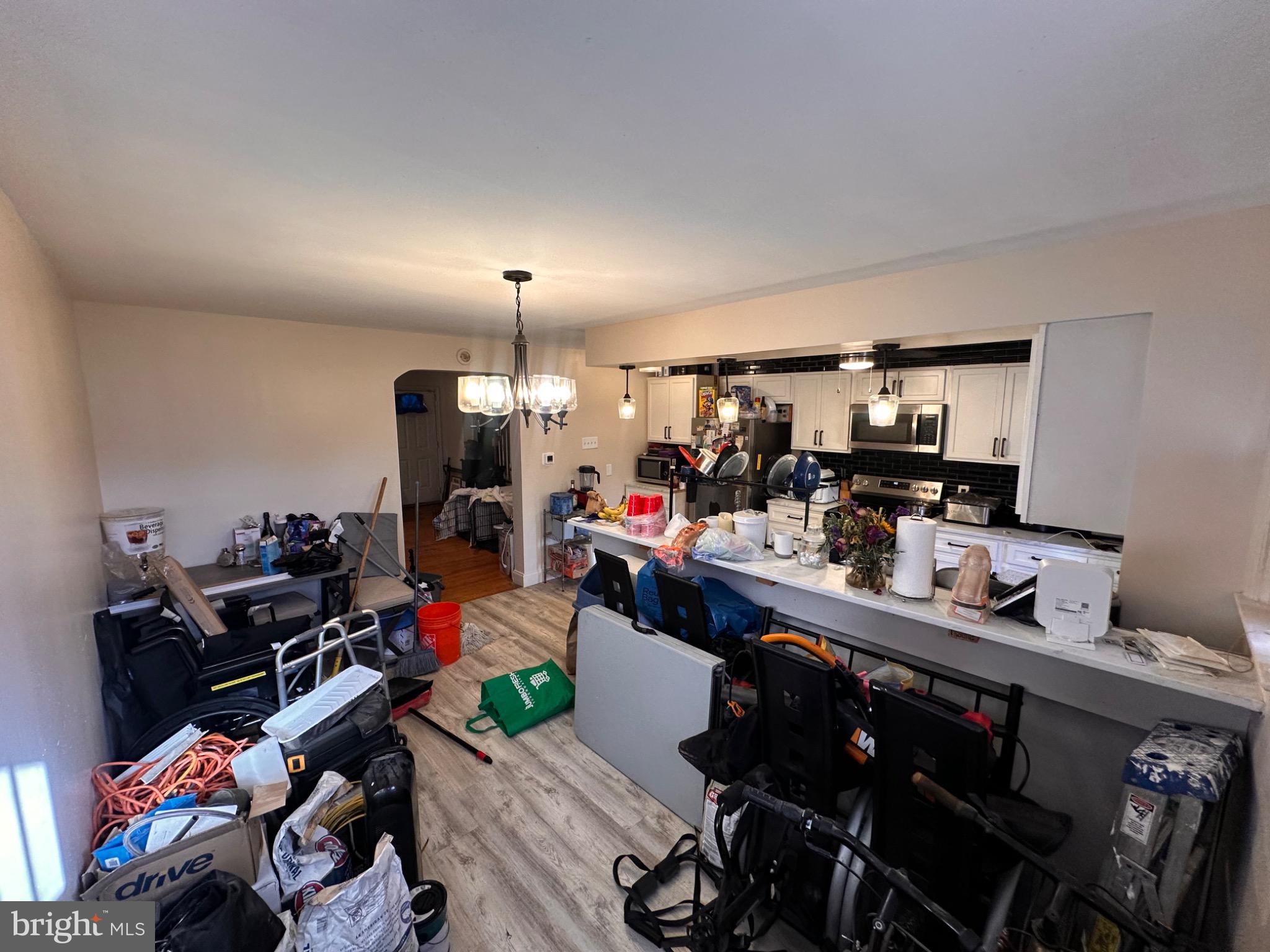 918 Cooks Lane Baltimore, MD 21229 - Photo 7 of 18 a kitchen with stainless steel appliances kitchen island granite countertop a sink dishwasher stove and cabinets
