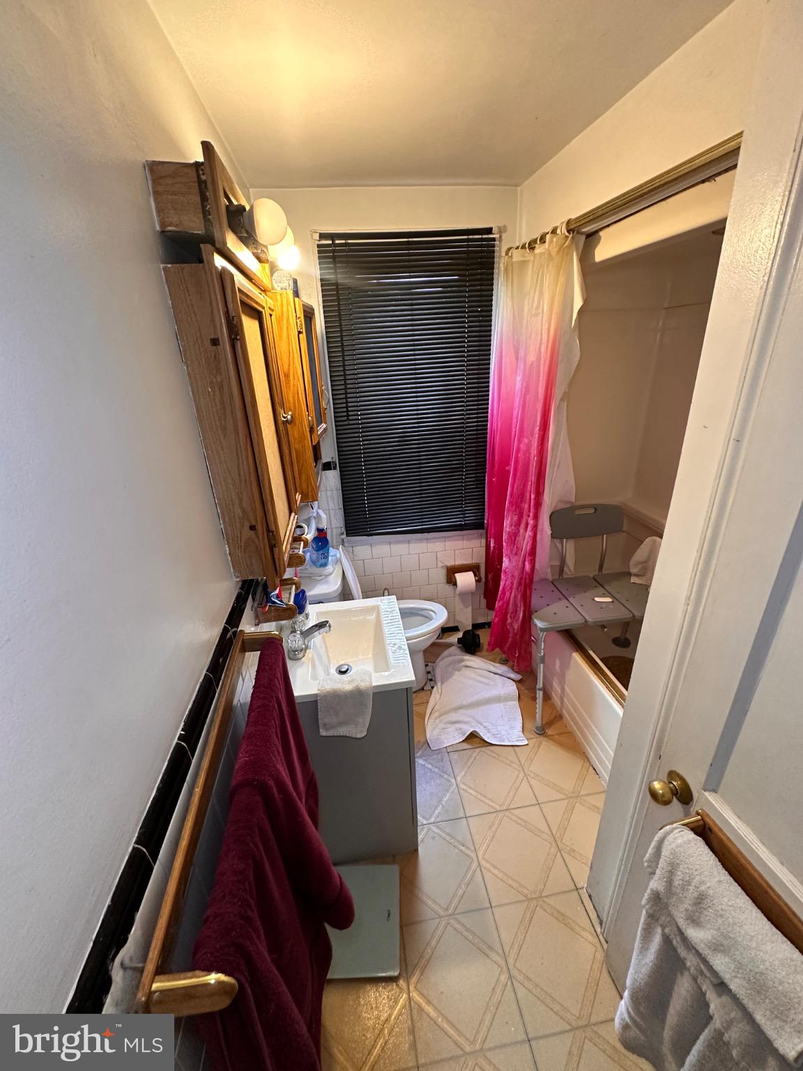 918 Cooks Lane Baltimore, MD 21229 - Photo 10 of 18 a view of walk in closet with clothes and shoes