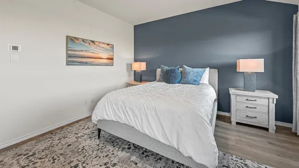 a bedroom with a bed and a dresser