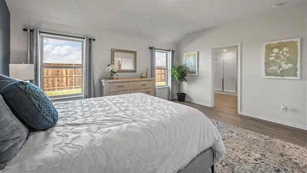a bedroom with a large bed and a window
