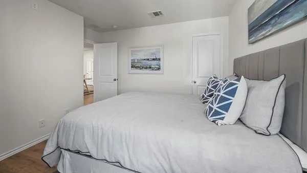 a bedroom with a bed and a night stand