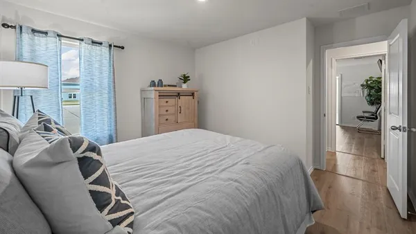 a bedroom with a bed and a lamp