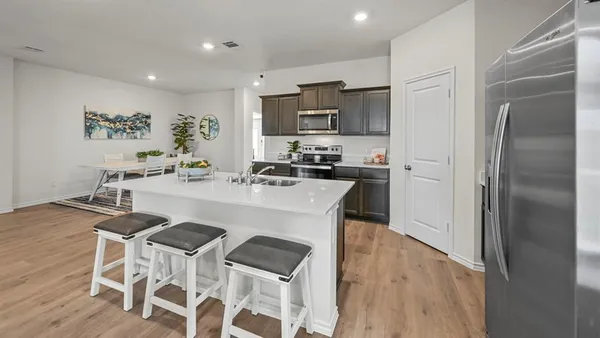 a kitchen with stainless steel appliances granite countertop a sink and stove