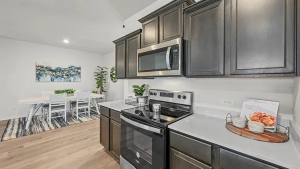 a kitchen with a stove a sink and a refrigerator