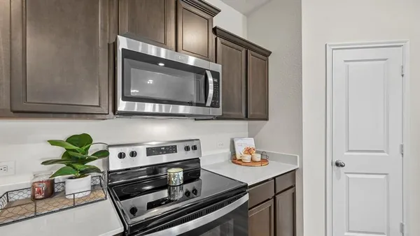 a kitchen with stainless steel appliances granite countertop a sink and a microwave
