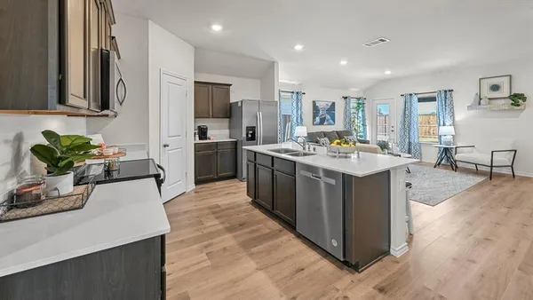 a kitchen with stainless steel appliances a stove microwave and cabinets
