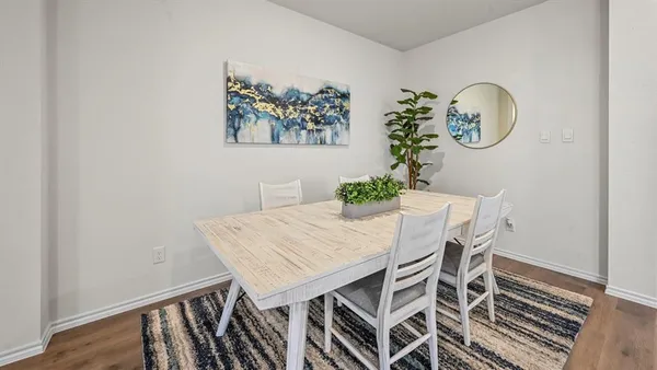 a kitchen with stainless steel appliances granite countertop a stove top oven a sink a refrigerator and white cabinets