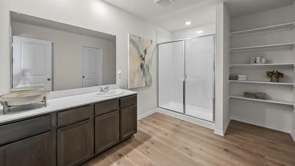 a bathroom with a double vanity sink mirror and shower