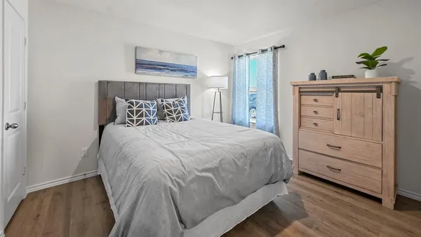 a bedroom with a bed and a dresser