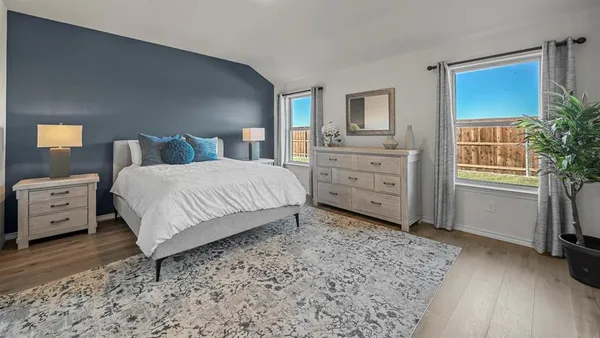a bedroom with a bed and a tv on the dresser