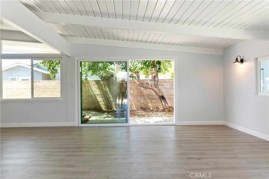 38995 Juniper Tree Road Palmdale, CA 93551 - Photo 16 of 22 a view of an empty room with wooden floor and a window