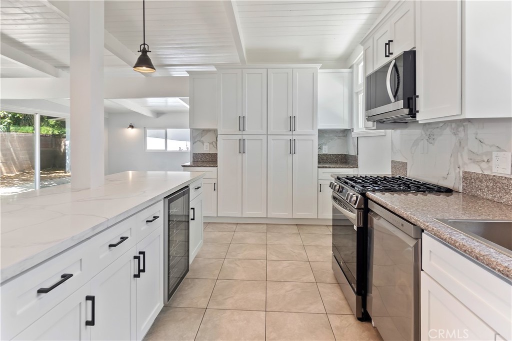 38995 Juniper Tree Road Palmdale, CA 93551 - Photo 9 of 22 a kitchen with stainless steel appliances granite countertop a refrigerator and a stove top oven