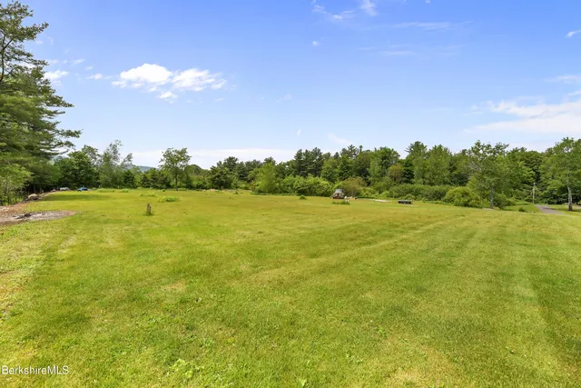 a view of a field with an trees in the background