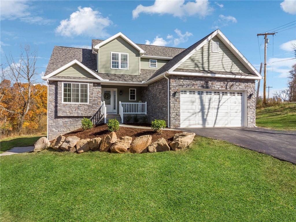 a front view of a house with a yard table and chairs