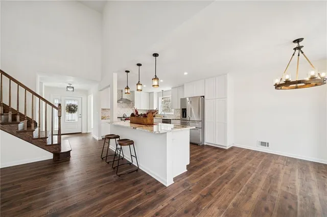 a view of kitchen with wooden floor and electronic appliances