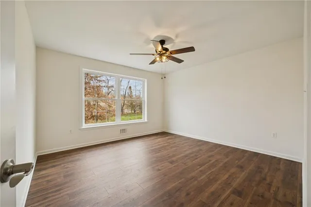 wooden floor in an empty room with a window