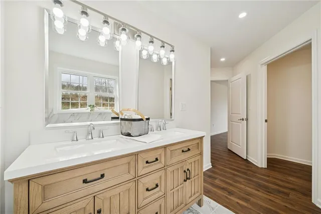 a bathroom with a double vanity sink mirror and
