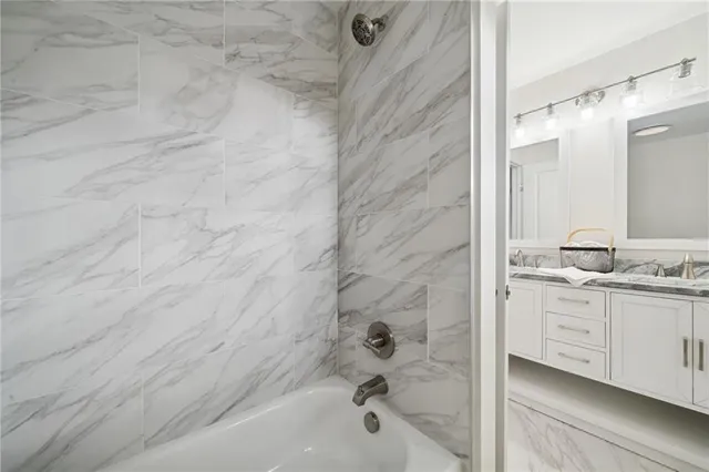 a bathroom with a bathtub and a sink