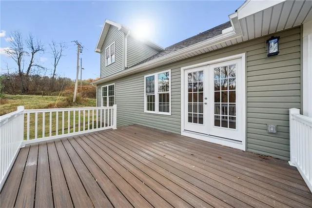 a view of a wooden deck with a yard