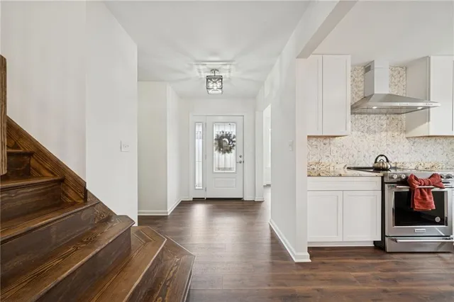 a kitchen with cabinets and wooden floor