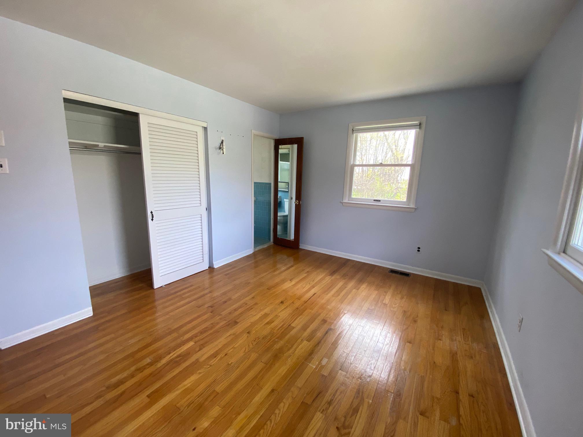 123 Cornwall Drive Chalfont, PA 18914 - Photo 11 of 37 an empty room with wooden floor and windows