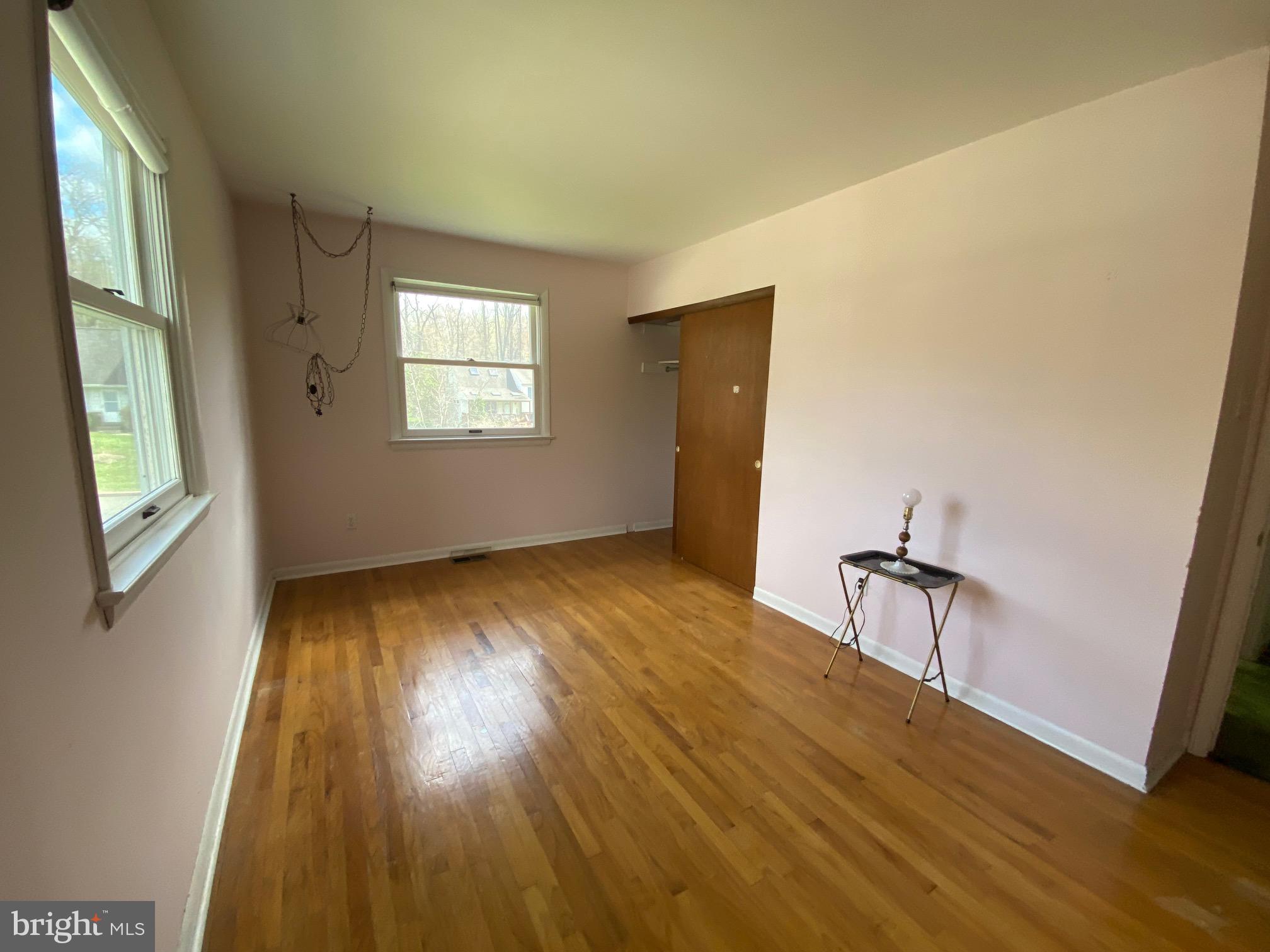 123 Cornwall Drive Chalfont, PA 18914 - Photo 14 of 37 a view of an empty room with wooden floor and a window