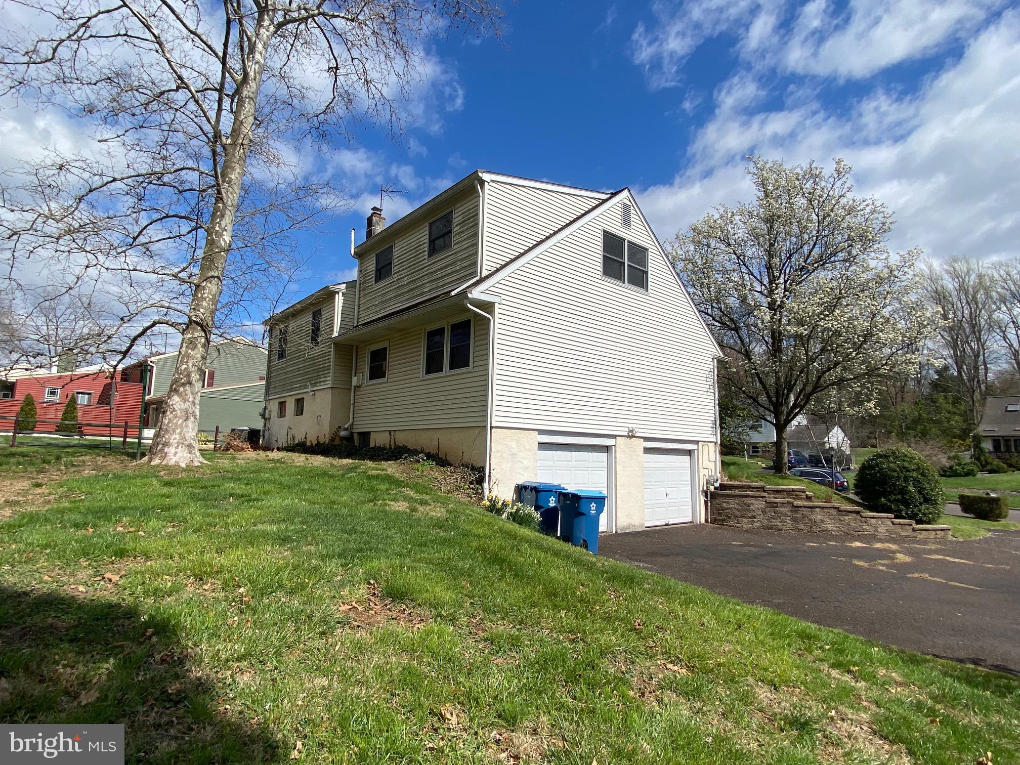 123 Cornwall Drive Chalfont, PA 18914 - Photo 36 of 37 a view of a white house next to a yard and a large tree