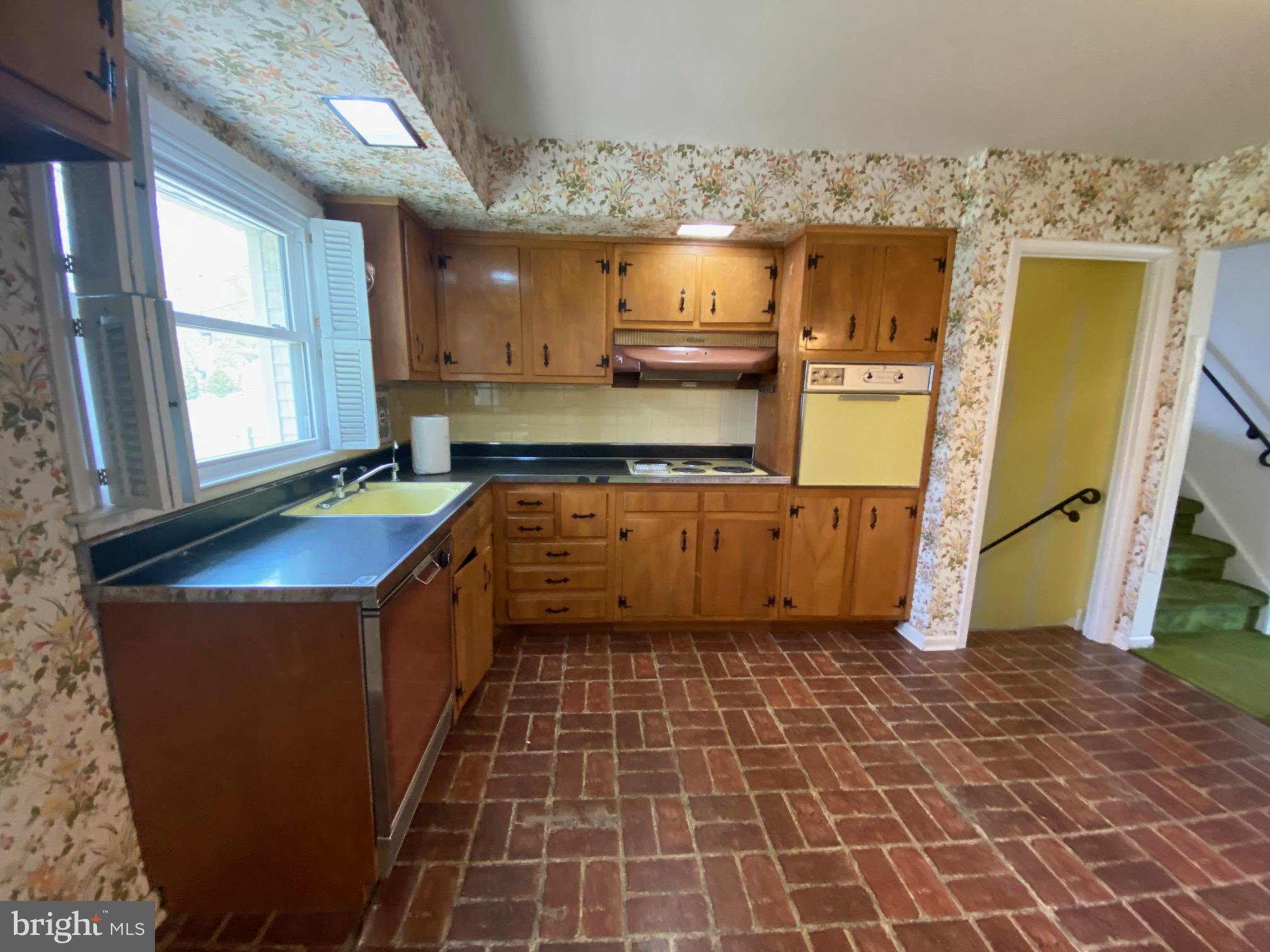 123 Cornwall Drive Chalfont, PA 18914 - Photo 7 of 37 a kitchen with granite countertop a sink a stove top oven and cabinets