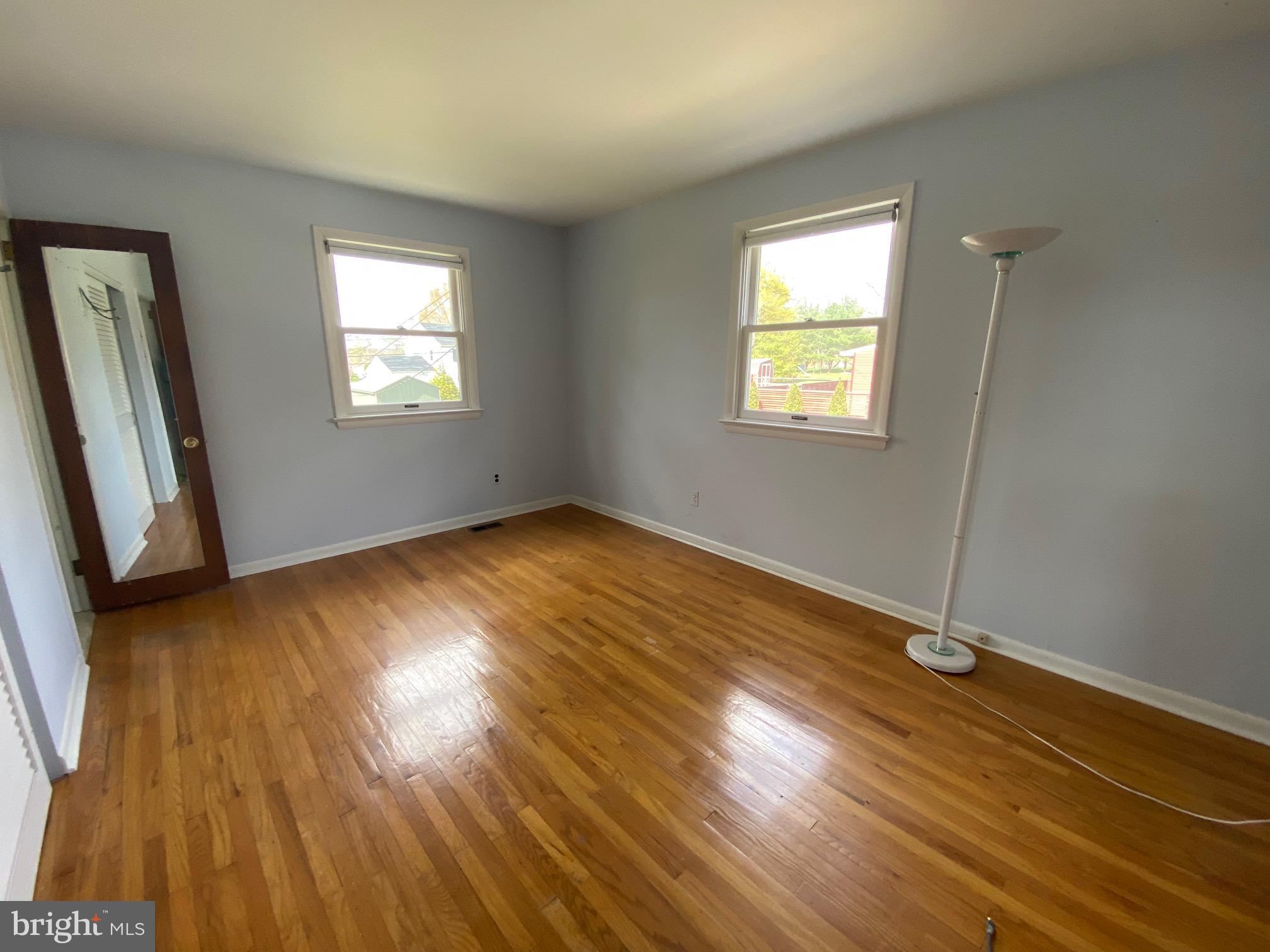 123 Cornwall Drive Chalfont, PA 18914 - Photo 10 of 37 a view of an empty room with wooden floor and a window