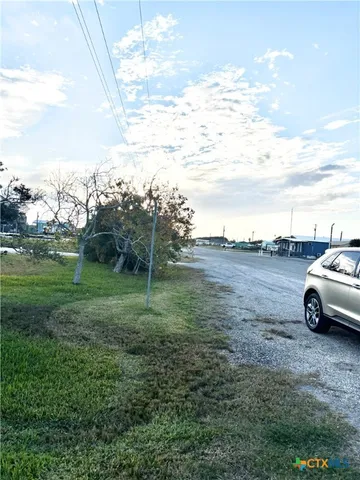 a view of yard with swimming pool and green space