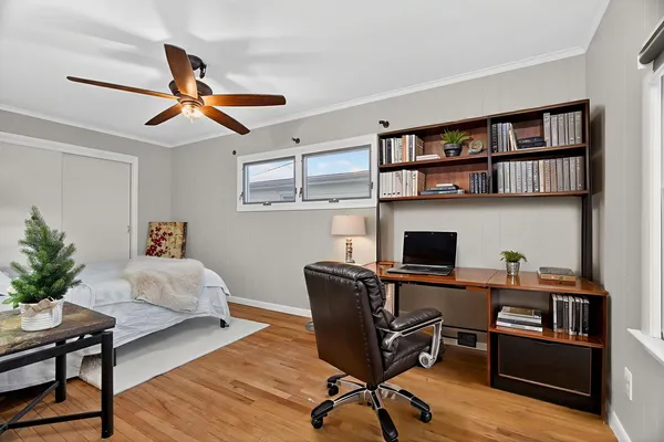 a bedroom with a bed and wooden floor