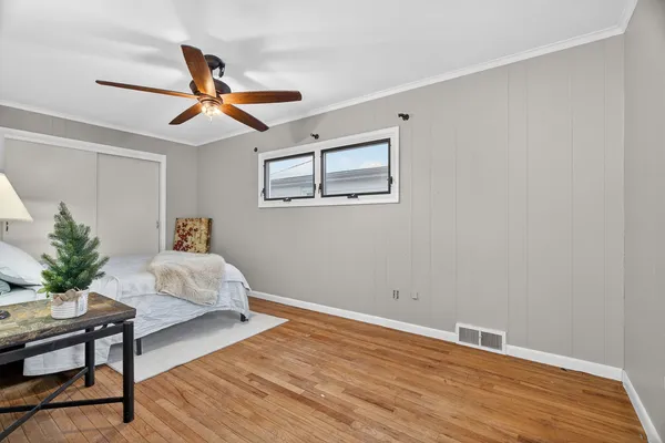 a bedroom with a large bed and a window